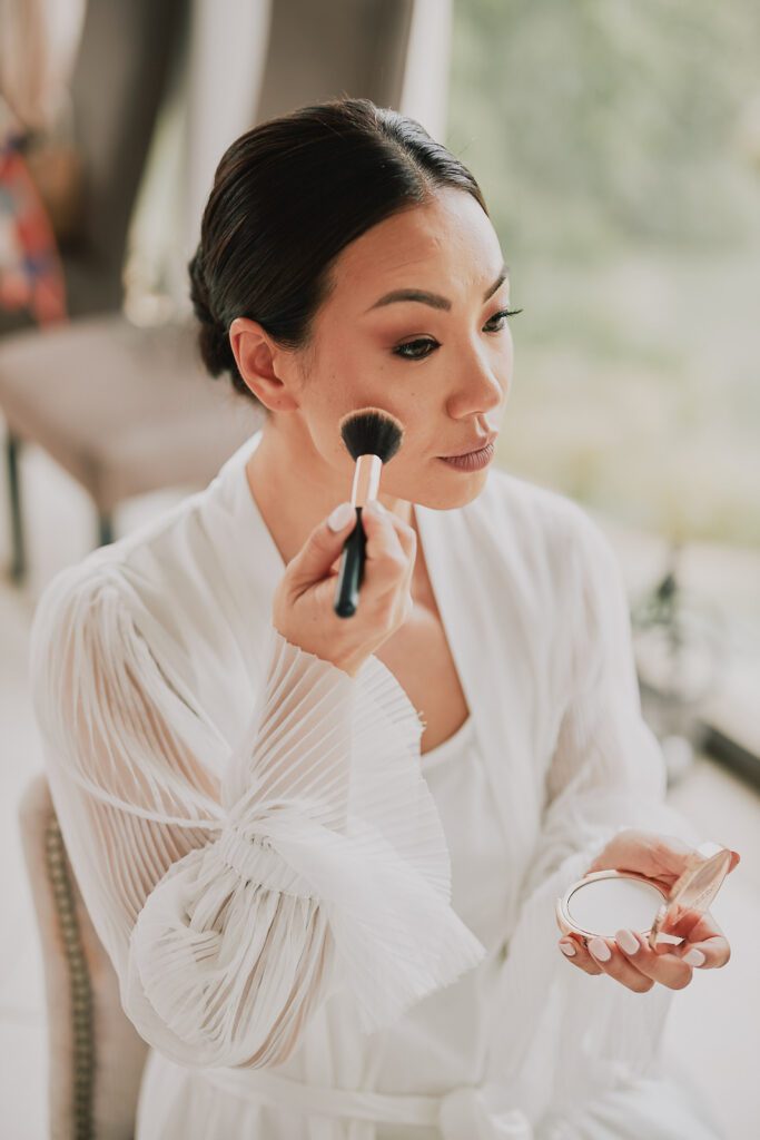 Bride putting make-up on