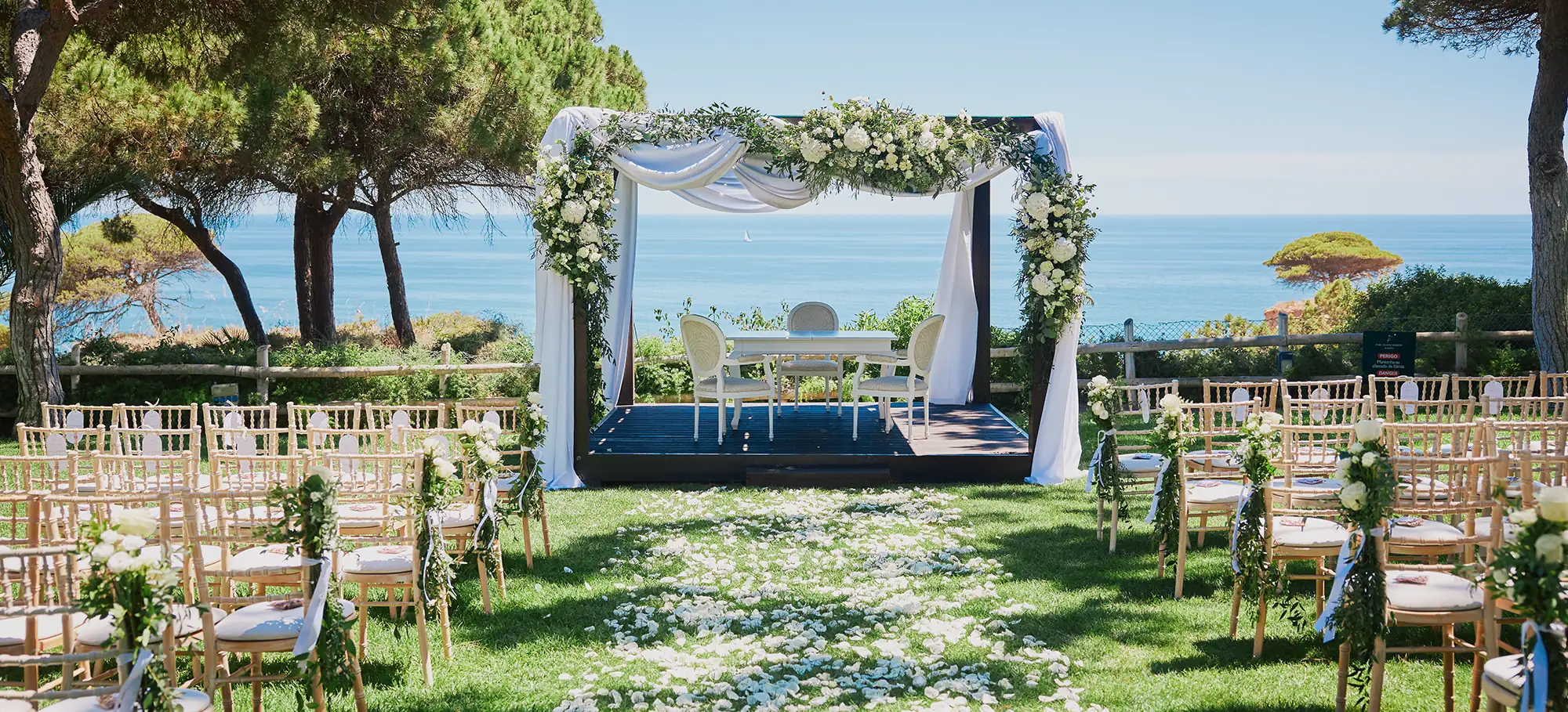 Luxury destination wedding ceremony setup overlooking the ocean in the Algarve, Portugal