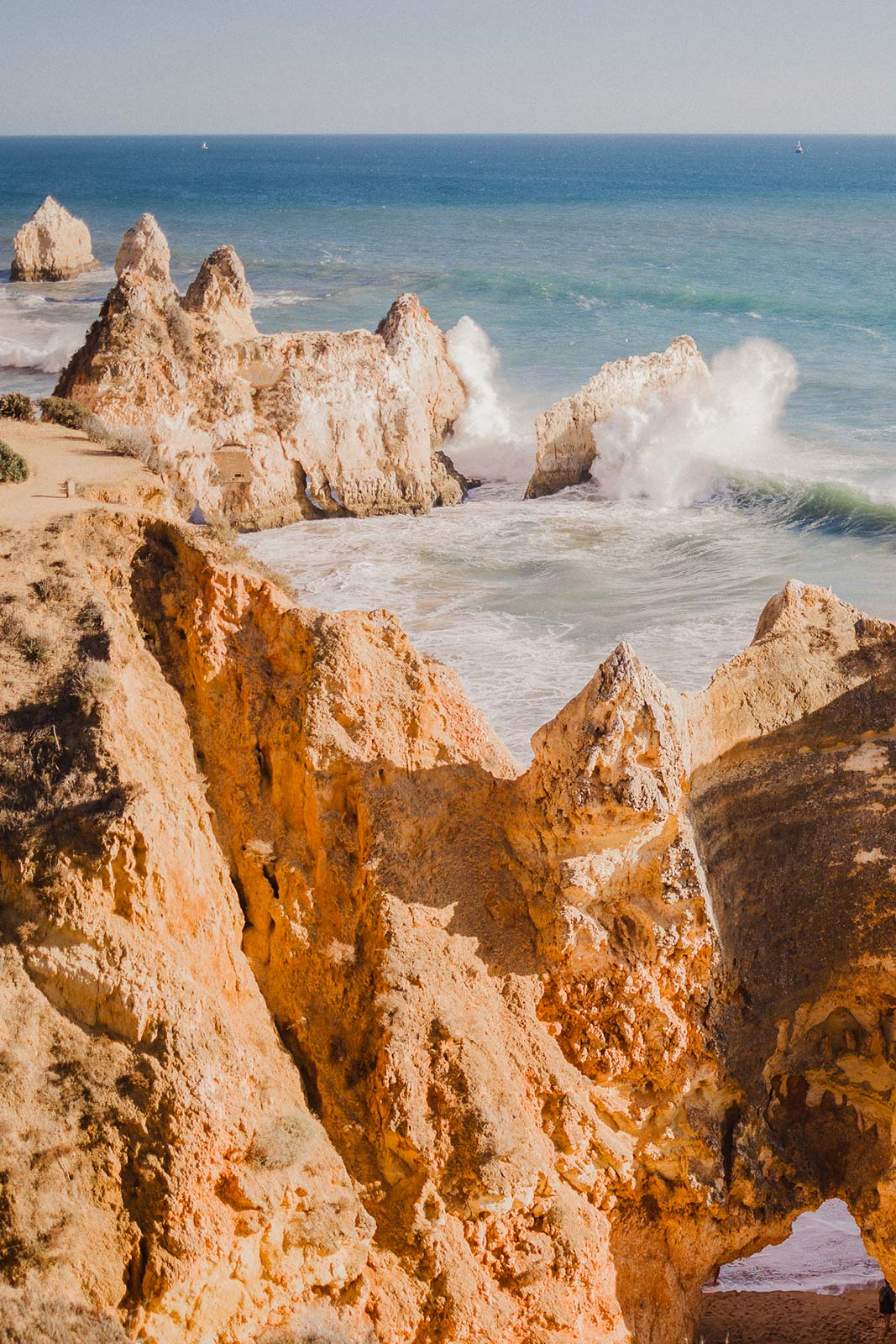 Hidden beach and dramatic cliffs along the Algarve coastline in Portugal overlooking the Atlantic Ocean